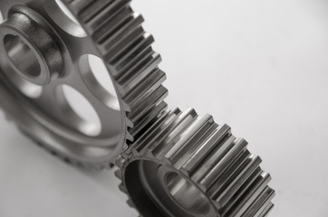 A gear wheel or pinion is a basic part of a gear train in the form of a disc with teeth on a cylindrical or conical surface meshing with the teeth of another gear