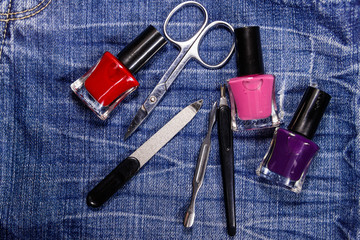 Basic set of manicure tools on jeans background