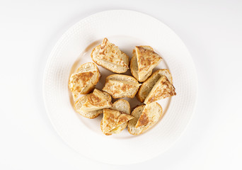 Top of omelette with bread on white plate. Typical spanish food.