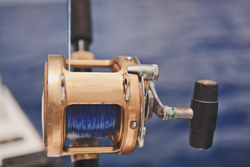 Spinning for sea fishing on the background of the blue ocean. Close up.