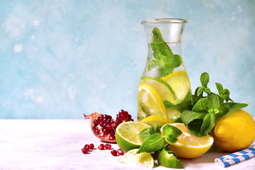 Cold summer citrus lemonade in a vintage bottle with ingredient for making.
