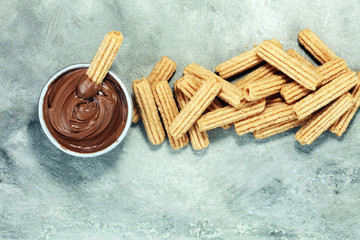 Traditional Spanish dessert churros with sugar and chocolate