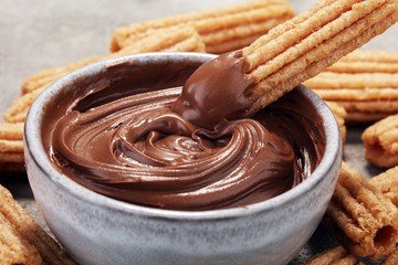 Traditional Spanish dessert churros with sugar and chocolate