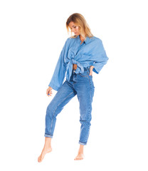 Young woman in blue jeans standing isolated on a white background