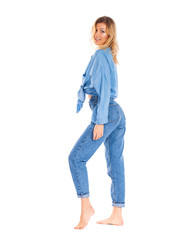 Young woman in blue jeans standing isolated on a white background