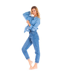 Young woman in blue jeans standing isolated on a white background