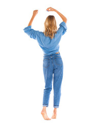 Young woman in blue jeans standing isolated on a white background