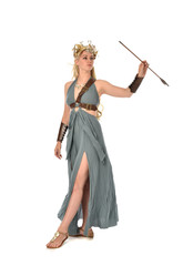 full length portrait of pretty blonde lady wearing fantasy toga gown,  and holding a bow and arrow. standing pose on white background.