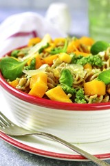 Whole grain fusilli pasta with pumpkin and pesto sauce.