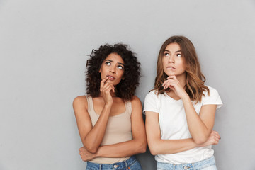 Portrait of two pensive young women looking away