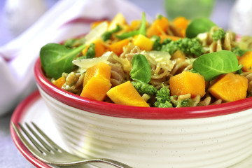 Whole grain fusilli pasta with pumpkin and pesto sauce.