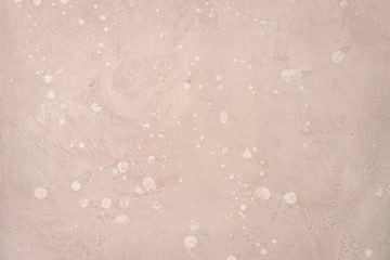 Light pink stone wall or floor.