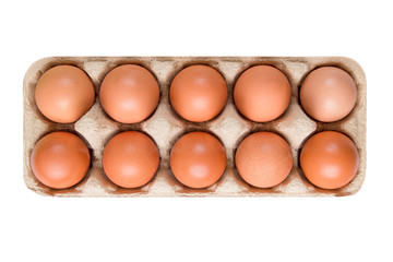packing; box of brown; beige eggs isolated on white background; top view; 10 pieces