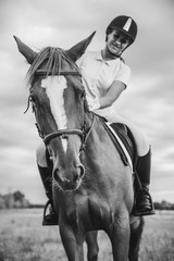 Obraz premium Girl jockey riding a horse