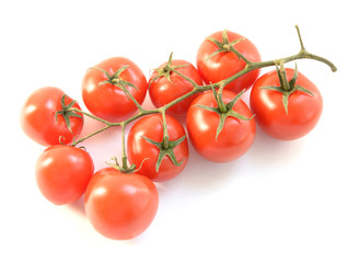 Natural-looking tomatoes on white background. Selective focus.