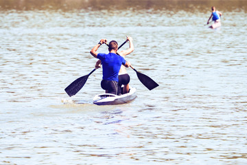 Professional sportsmen swimming on kayak
