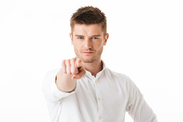 Portrait of a confident young man pointing finger
