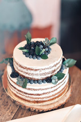Wedding or birthday cake with berries. Sweet pie on banquet in restaurant.