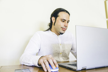 Modern designer working on laptop closeup in urban office style workspace