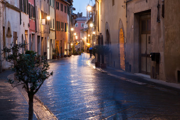 Fototapeta na wymiar streets at night in San Quirico d'Orcia after rain, Tuscany, Italy
