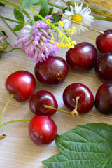 cherries and flowers on the table