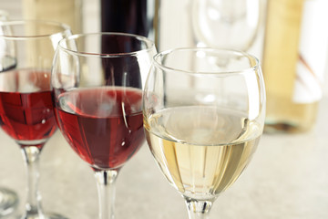 Elegant glasses with delicious wine on table