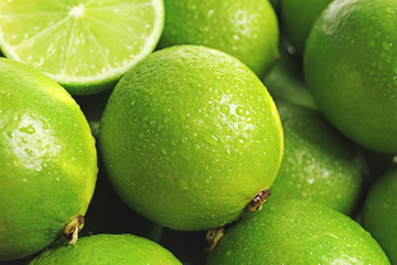 Fresh ripe green limes as background