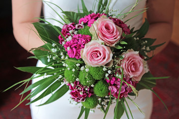 bridal bouquet, held by the bride