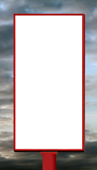 Blank vertical billboard against a sunset sky.