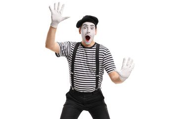 Mime holding his hands against an invisible wall