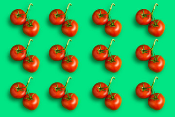 Colorful pattern of red ripe tomatoes on a green background.