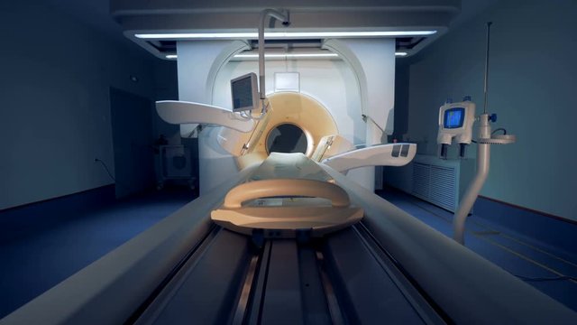 Wide angle view of an empty MRI CT PET scanner. Tomograph is entering the state of readiness.