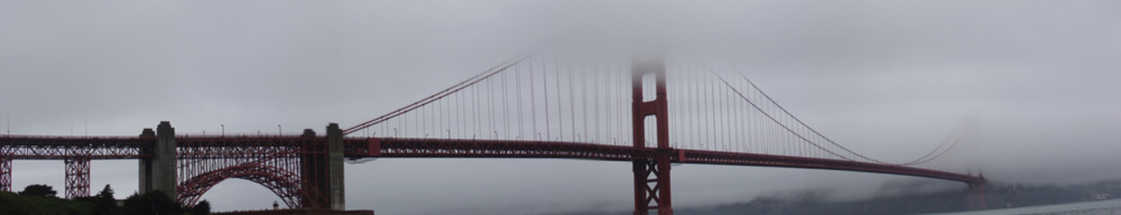 Panorama of the San Francisco Golden Gate Bridge in the mist of a foggy day
