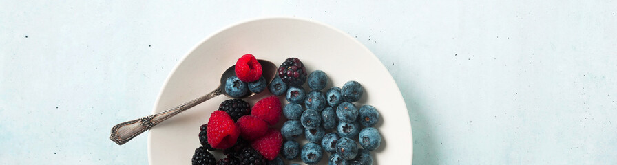 Fruit salad with Various fresh summer berries in white plate . T
