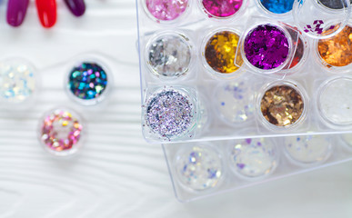 Table full of manicure utensils, manicure tools, nail polish colours on palette. Nails art accessories. Top view