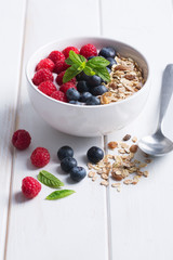 Smoothie bowl with yogurt, fresh berries and cereal. Copy space