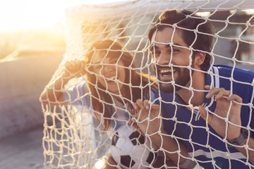 Couple in a goal net