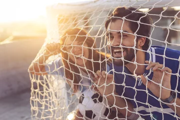 Fotobehang Couple in a goal net © Impact Photography