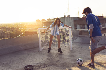Couple playing football
