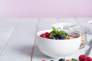 Smoothie bowl with yogurt, fresh berries and cereal