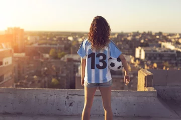 Fotobehang Woman wearing a football jersey © Impact Photography