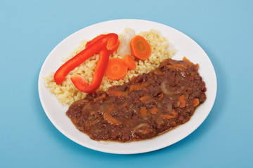 Azuki with vegetables on steam and bulgur on a blue
