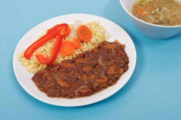 Azuki with vegetables on steam and bulgur on a blue