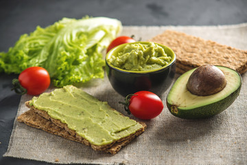 Mexican cold appetizer made of pureed avocado pulp with bread and vegetables. Concept healthy vegetarian Breakfast