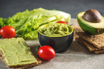Mexican cold appetizer made of pureed avocado pulp with bread and vegetables. Concept healthy vegetarian Breakfast