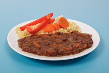 Azuki with vegetables on steam and bulgur on a blue