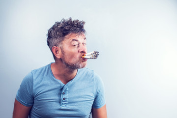 Young man with many cigarettes in his mouth
