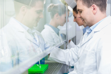 Researchers in science lab preparing samples for analysis