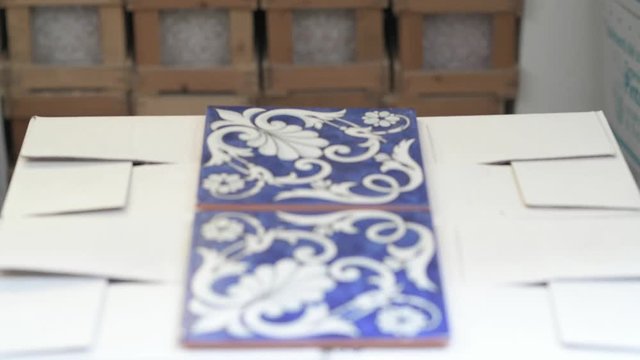 Blue ceramic tiles with white arabesque desing in alternate focus