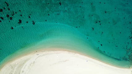 Aerial drone bird's eye view photo of tropical caribbean sandy beach with emerald crystal clear waters